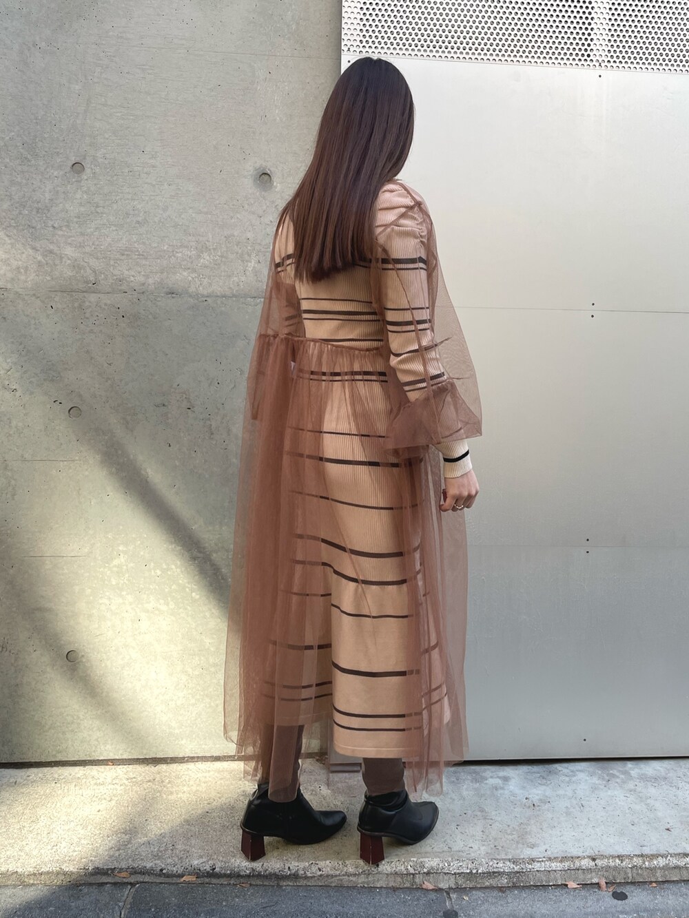 ベージュ系のワンピースを着用したレディースの冬コーディネートの4枚目の写真