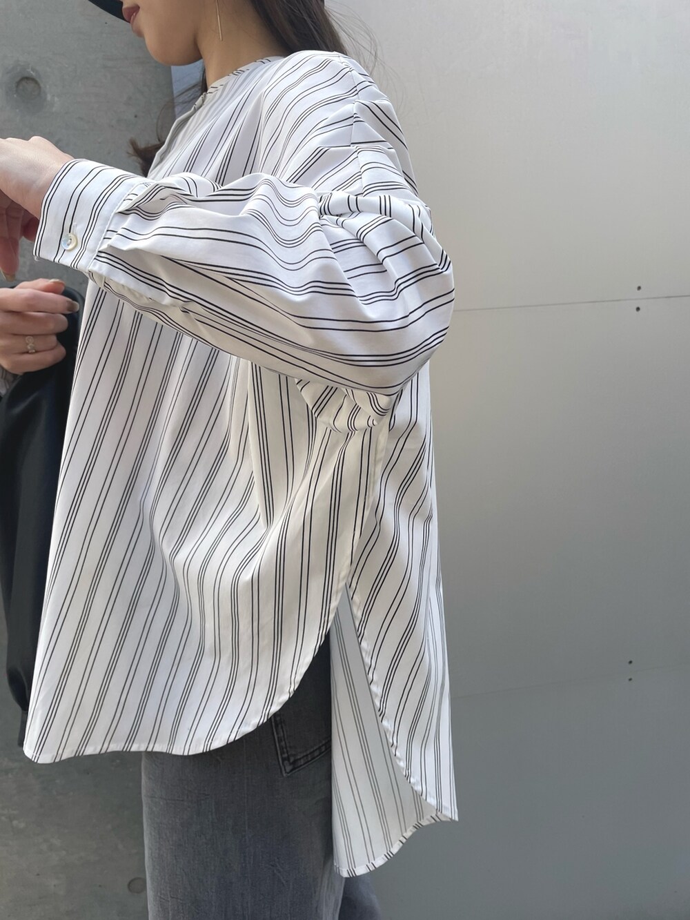 ホワイト系のシャツ/ブラウス、ブラック系のデニムパンツ、ブラック系のブルゾンを着用したレディースの春コーディネートの5枚目の写真