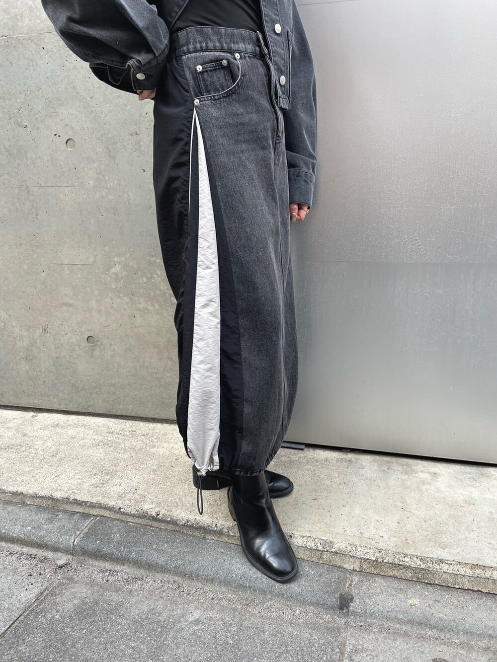 ブラック系のデニムジャケット、ブラック系のキャミソールを着用したレディースの春コーディネートの4枚目の写真