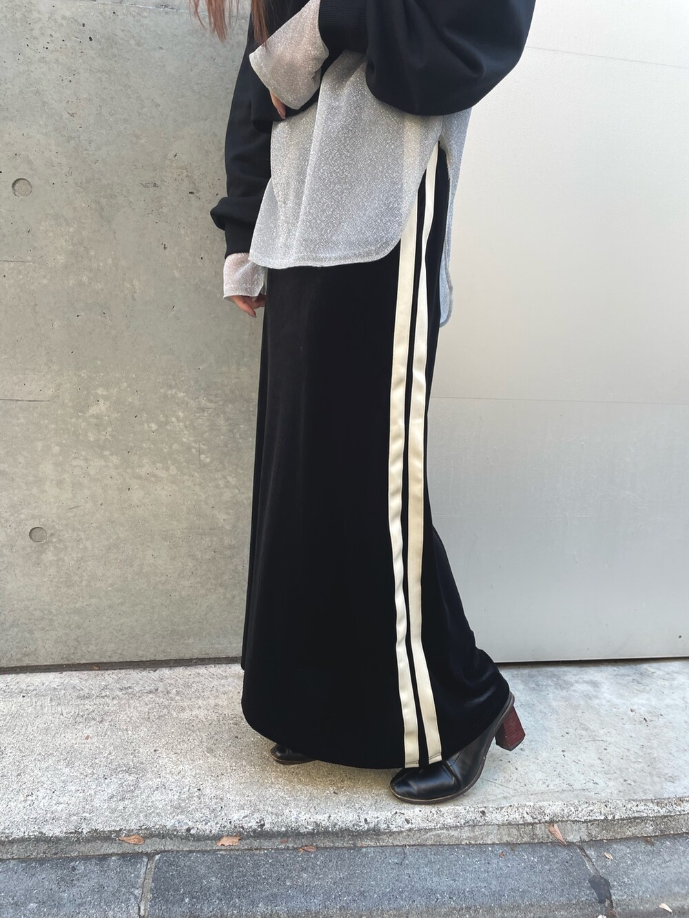 ブラック系のスウェット、ホワイト系のTシャツ/カットソー、ブラック系のスカートを着用したレディースの冬コーディネートの6枚目の写真