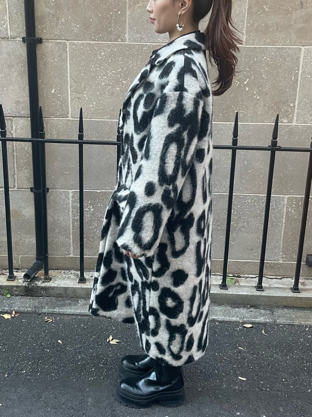 ベージュ系のチェスターコート、ゴールド系のピアス（両耳用）を着用したレディースの秋コーディネートの6枚目の写真