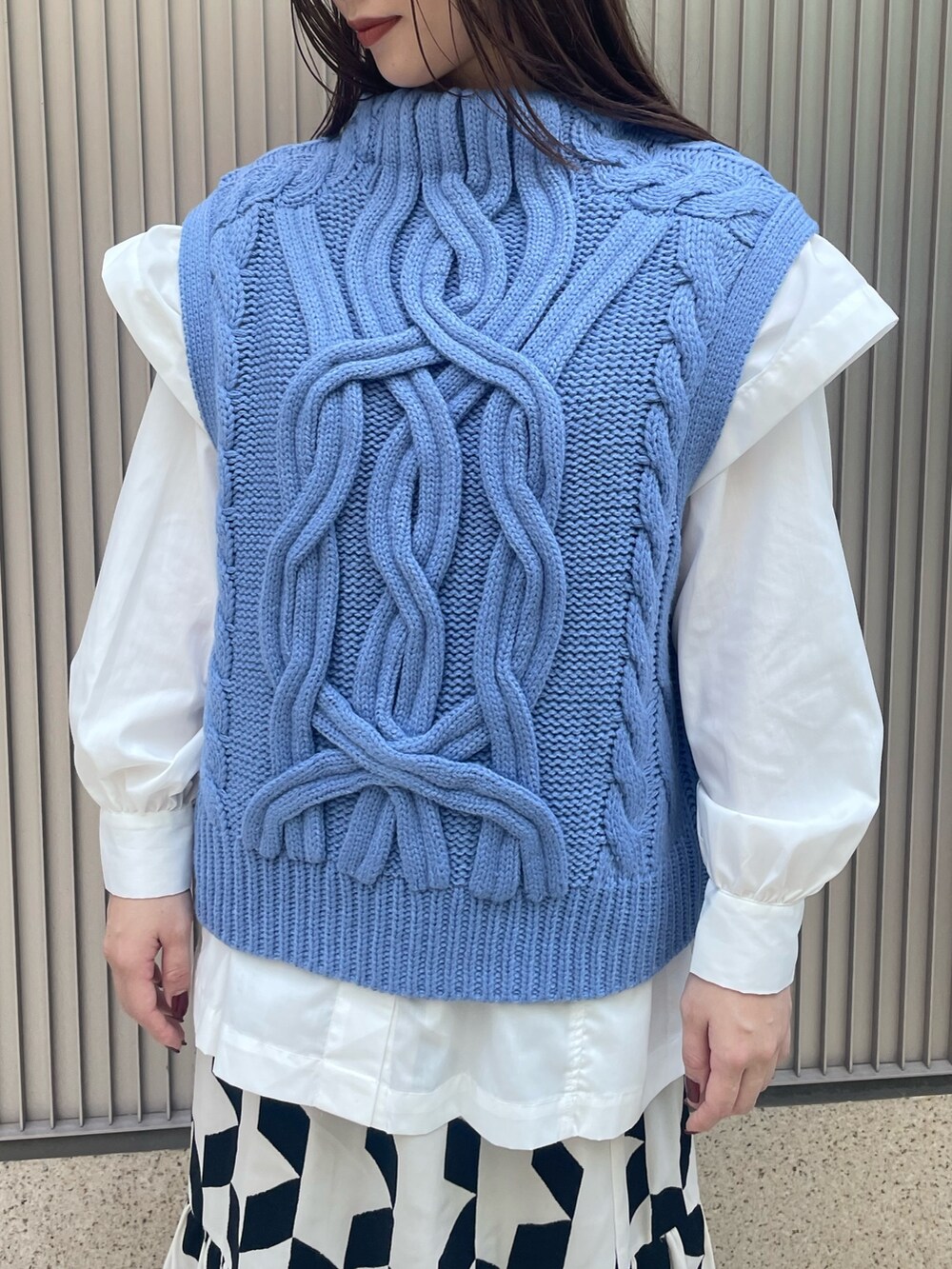 ブラック系のスカート、ブルー系のベスト、ホワイト系のシャツ/ブラウスを着用したレディースの冬コーディネートの7枚目の写真