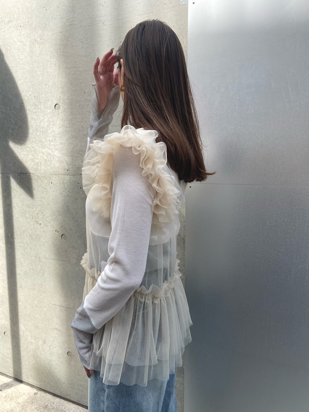 ホワイト系のTシャツ/カットソー、ブルー系のデニムパンツ、ベージュ系のスニーカーを着用したレディースの春コーディネートの3枚目の写真