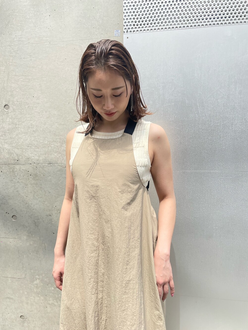 ホワイト系のニット/セーター、ベージュ系のワンピース、ブラック系のサンダルを着用したレディースの春コーディネートの3枚目の写真