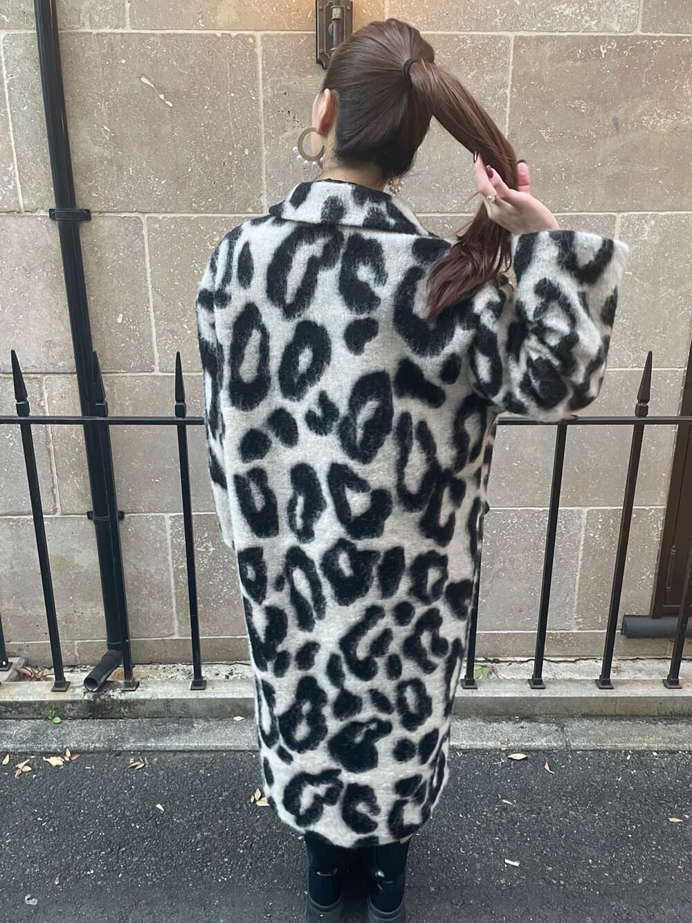 ベージュ系のチェスターコート、ゴールド系のピアス（両耳用）を着用したレディースの秋コーディネートの5枚目の写真