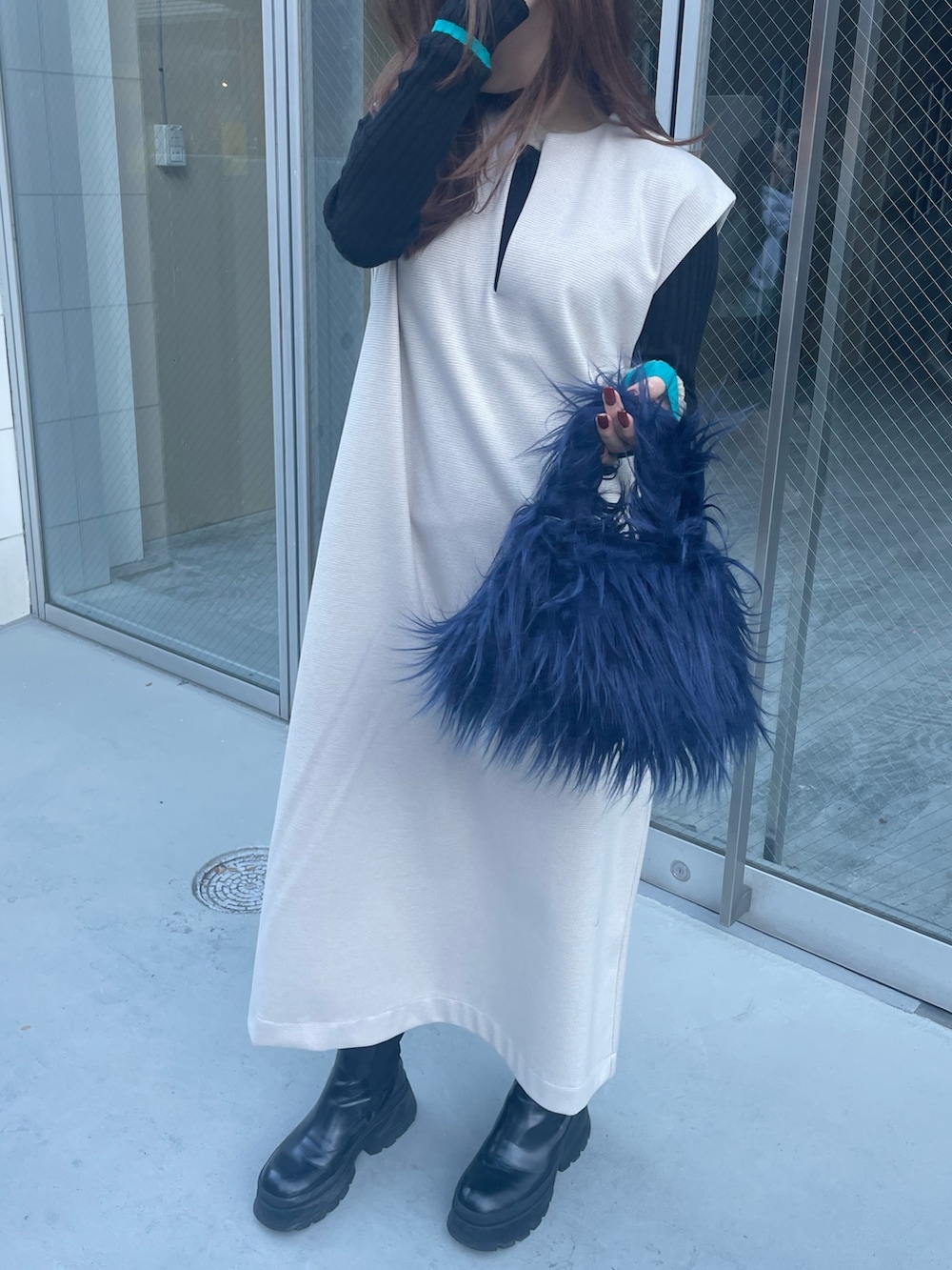 ブルー系のハンドバッグ、ブラック系のニット/セーター、ホワイト系のワンピースを着用したレディースの秋コーディネートの8枚目の写真