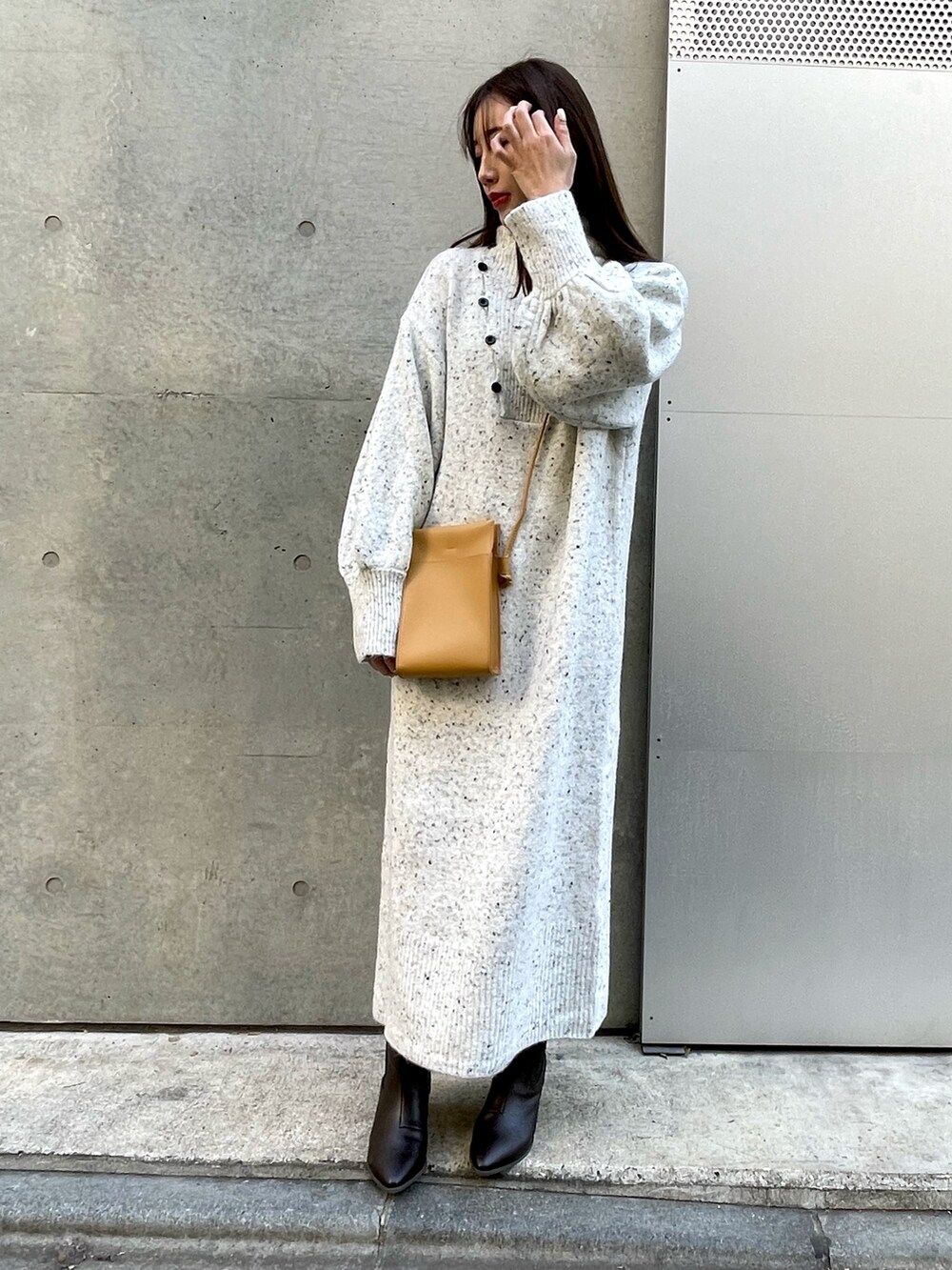 ホワイト系のワンピース、ベージュ系のショルダーバッグを着用したレディースの冬コーディネートの2枚目の写真