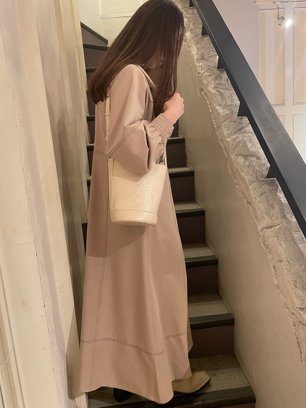 ホワイト系のショルダーバッグ、グレー系のワンピースを着用したレディースの冬コーディネートの4枚目の写真