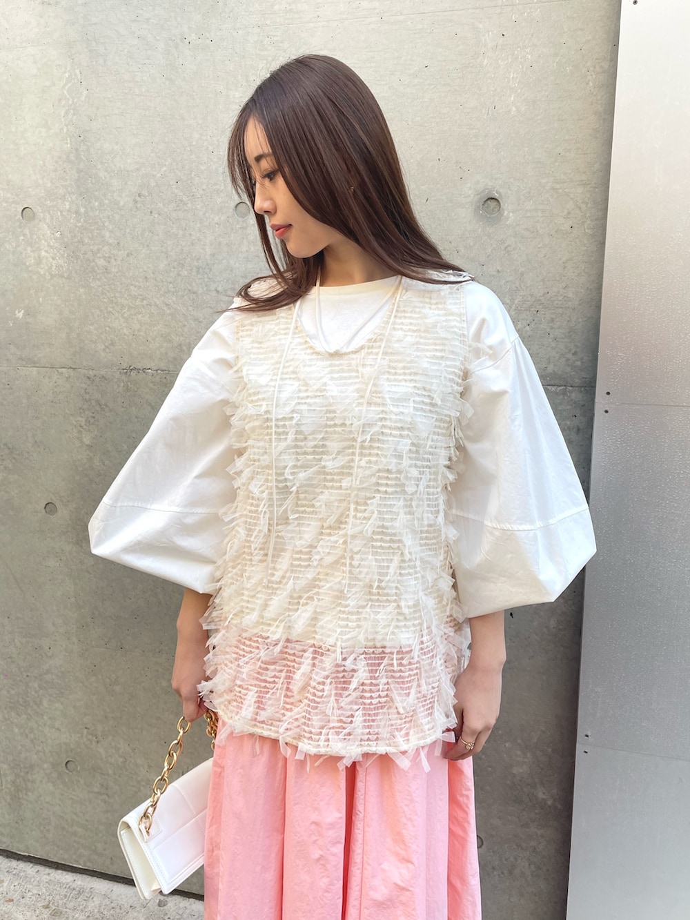 ピンク系のスカート、ホワイト系のシャツ/ブラウス、ホワイト系のベストを着用したレディースの冬コーディネートの4枚目の写真