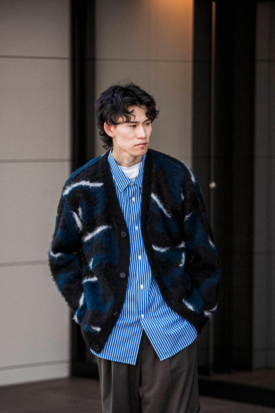 ブラウン系のスラックス、ブルー系のシャツ/ブラウス、ブルー系のカーディガン/ボレロを着用したメンズの秋コーディネートの2枚目の写真