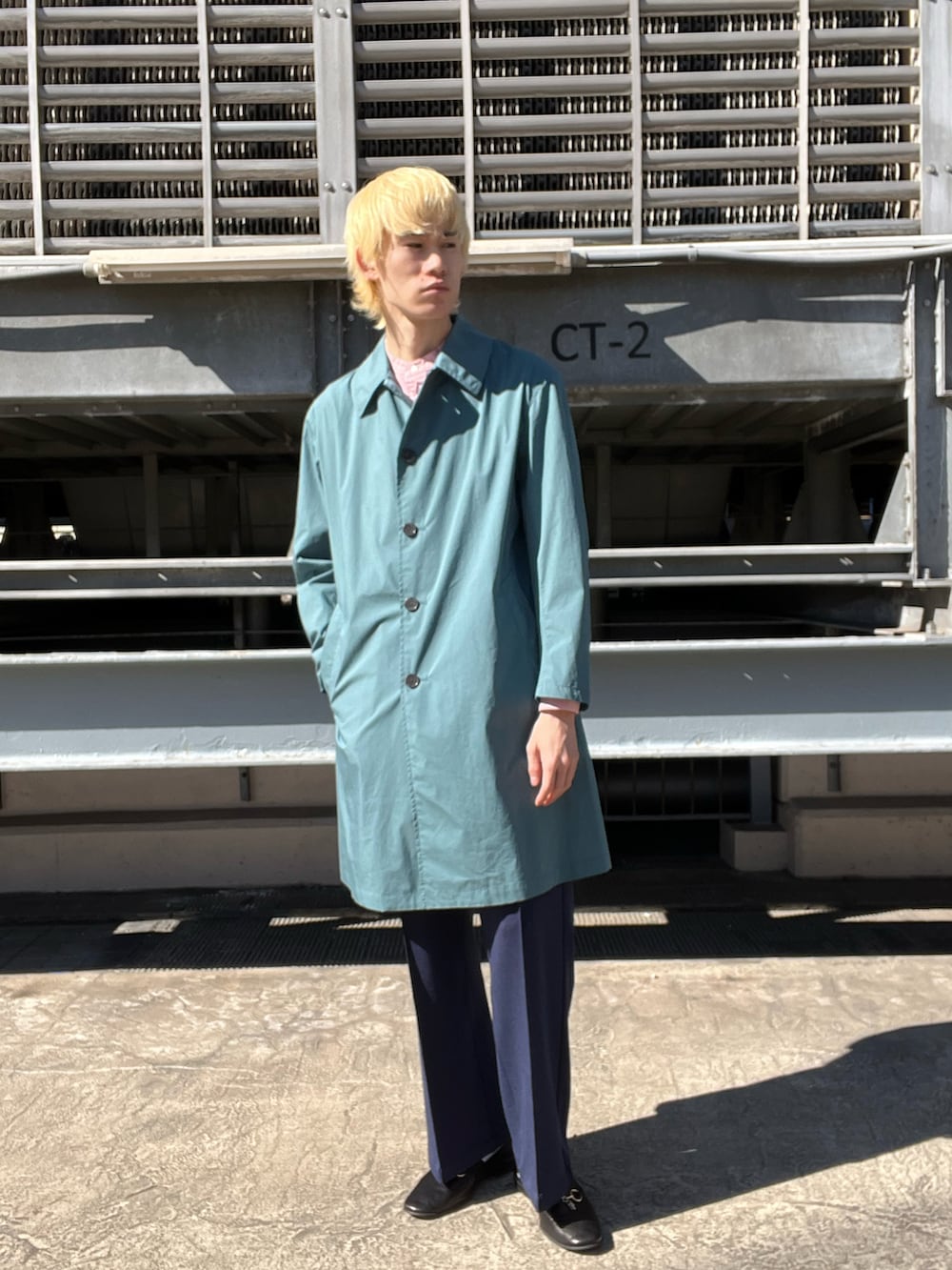 ブラック系のシューズ、グリーン系のその他パンツ、グリーン系のステンカラーコートを着用したメンズの春コーディネートの2枚目の写真