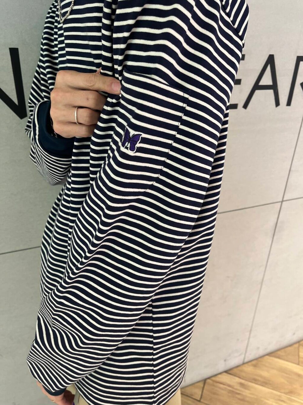 その他のTシャツ/カットソー、ベージュ系のチノパンツ、オレンジ系のキャップを着用したメンズの秋コーディネートの2枚目の写真