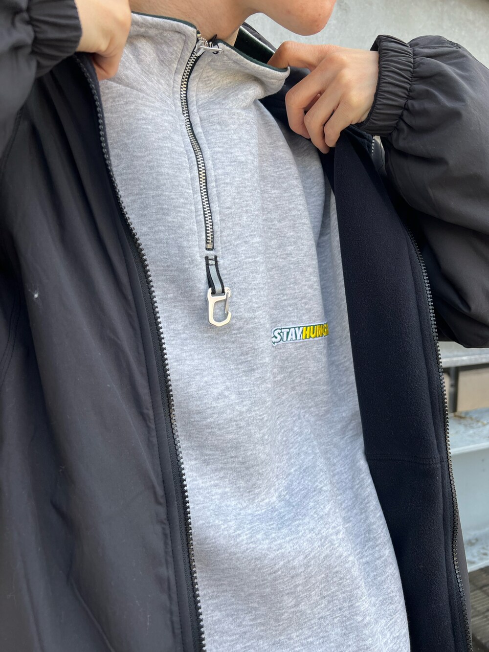 オレンジ系のスニーカー、ブルー系のパンツ、ブラック系のブルゾンを着用したメンズの秋コーディネートの3枚目の写真