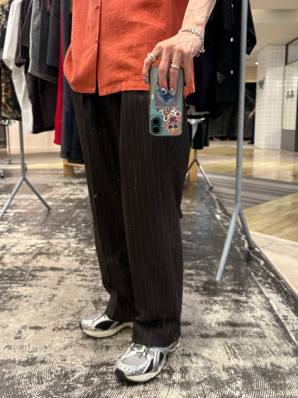 オレンジ系のシャツ/ブラウス、ブラウン系のその他パンツ、シルバー系のスニーカーを着用したメンズの夏コーディネートの3枚目の写真