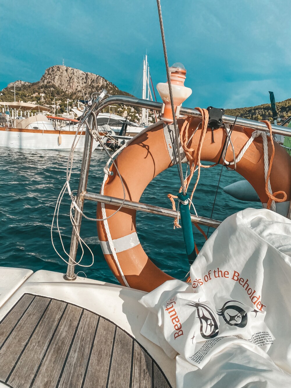 ホワイト系のTシャツ/カットソー、グレー系のチノパンツ、ブラック系のサングラスを着用したメンズの秋コーディネートの3枚目の写真