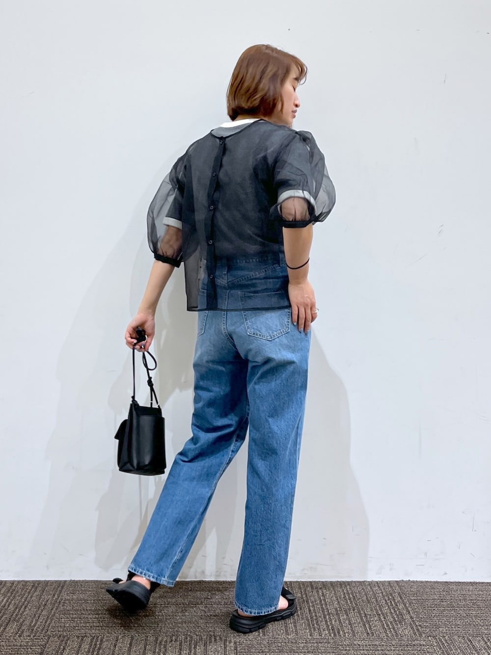 グレー系のTシャツ/カットソー、ブルー系のパンツ、ブラック系のシャツ/ブラウスを着用したレディースの春コーディネートの3枚目の写真