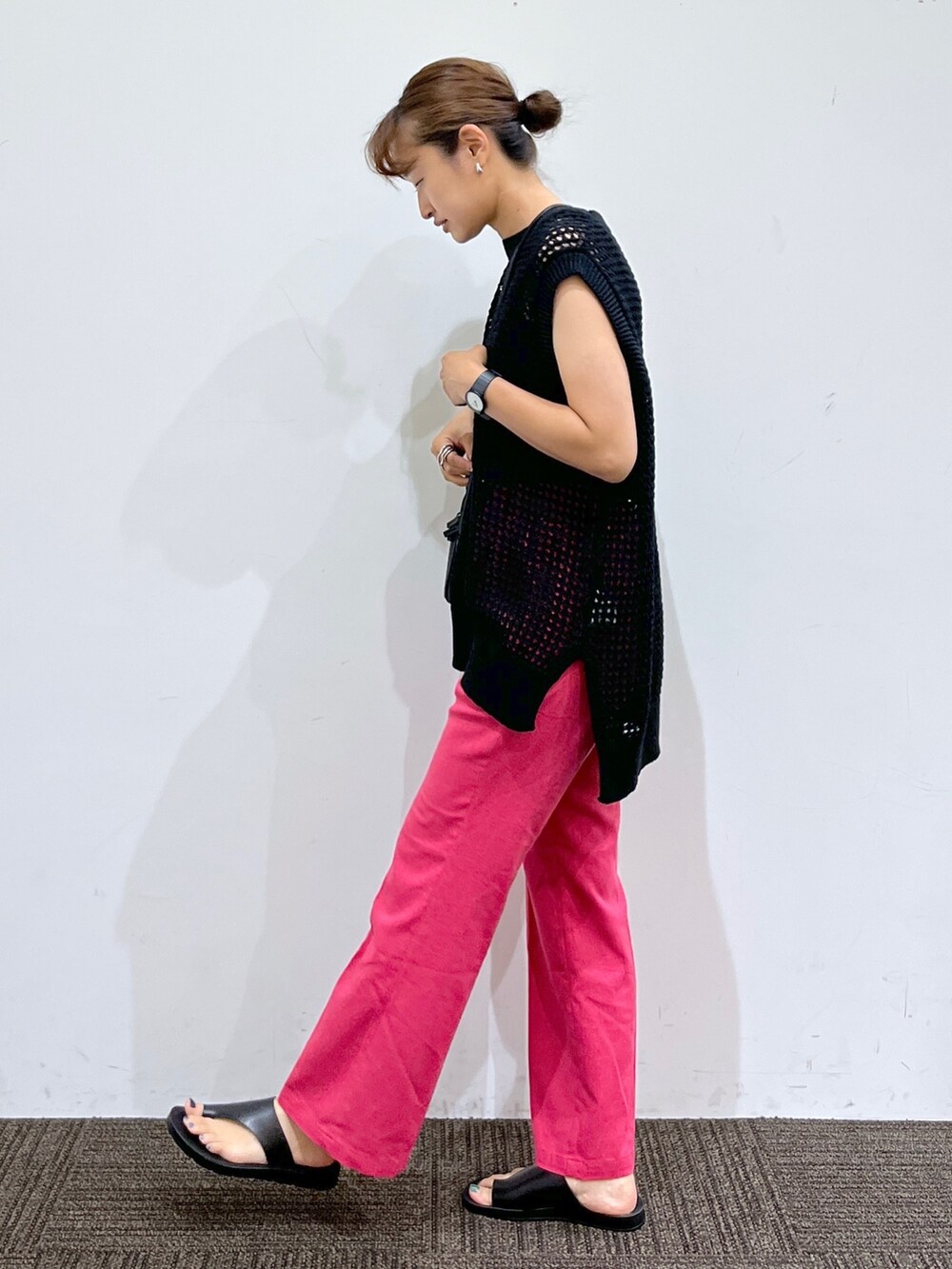 ブラック系のサンダル、ピンク系のスラックス、ブラック系のショルダーバッグを着用したレディースの夏コーディネートの2枚目の写真