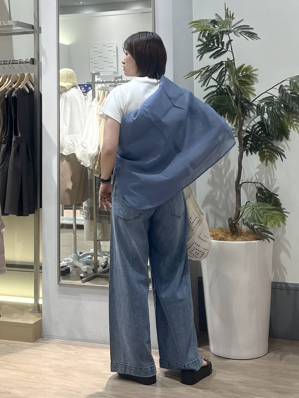 ブルー系のデニムパンツ、ブルー系のシャツ/ブラウス、ホワイト系のTシャツ/カットソーを着用したレディースの夏コーディネートの4枚目の写真