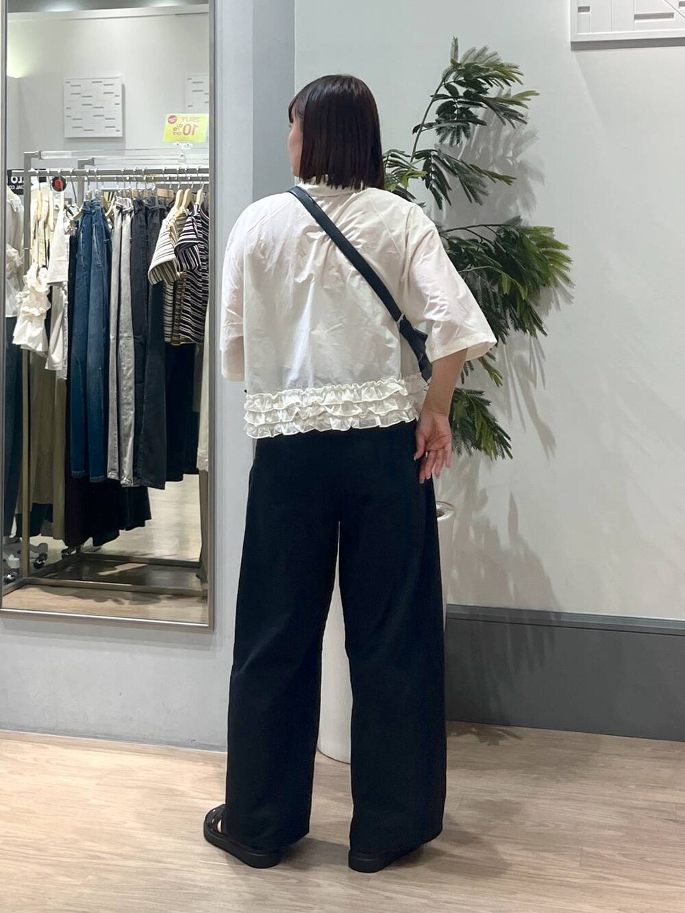 ブラック系のサンダル、ホワイト系のシャツ/ブラウス、ブラック系のショルダーバッグを着用したレディースの夏コーディネートの4枚目の写真