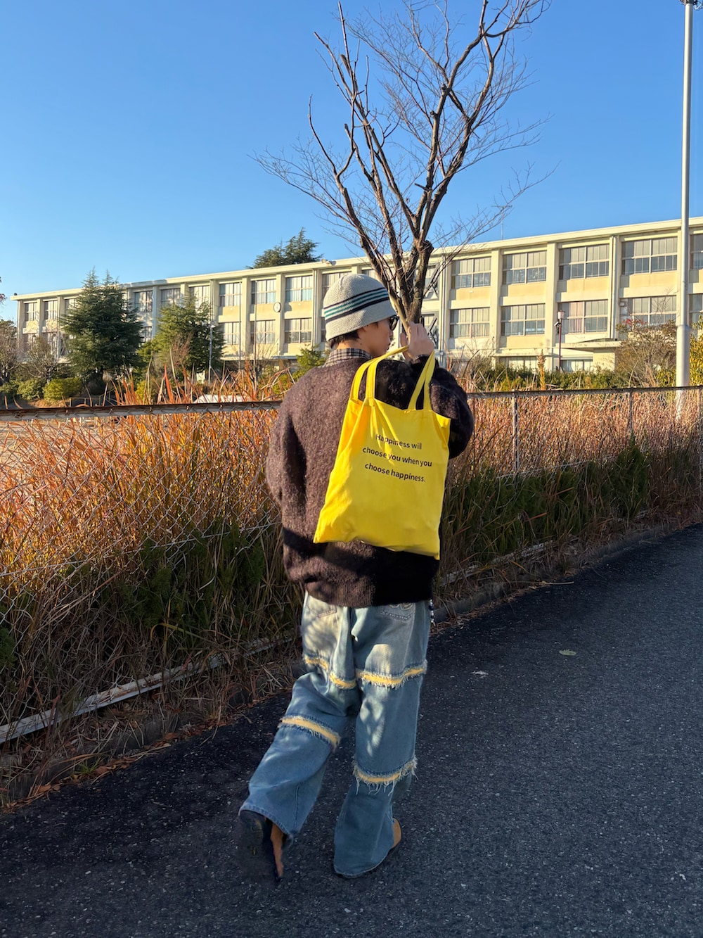 ブラック系のニット/セーター、ブルー系のデニムパンツ、ブラウン系のスニーカーを着用したメンズの冬コーディネートの2枚目の写真