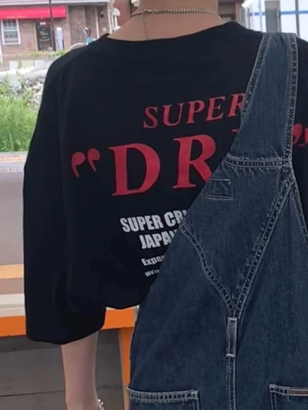 ブラック系のTシャツ/カットソー、ブルー系のサロペット/オーバーオール、ホワイト系のスニーカーを着用したレディースの夏コーディネートの2枚目の写真