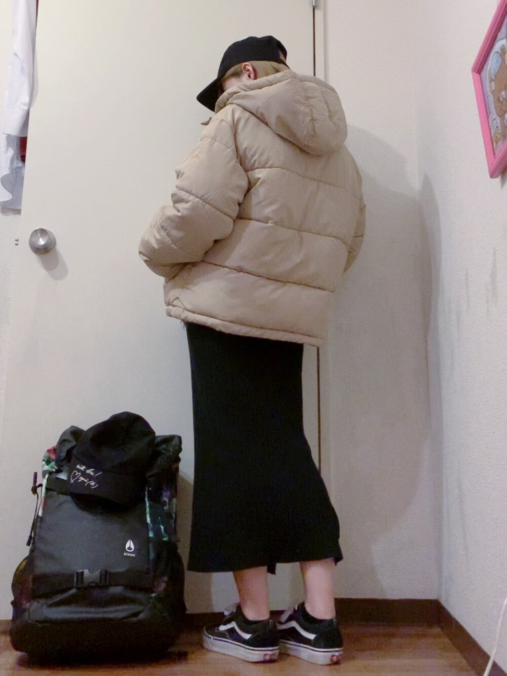 ベージュ系のダウンジャケット/コート、ブラック系のニット/セーター、ブラック系のスカートを着用したレディースの冬コーディネートの5枚目の写真