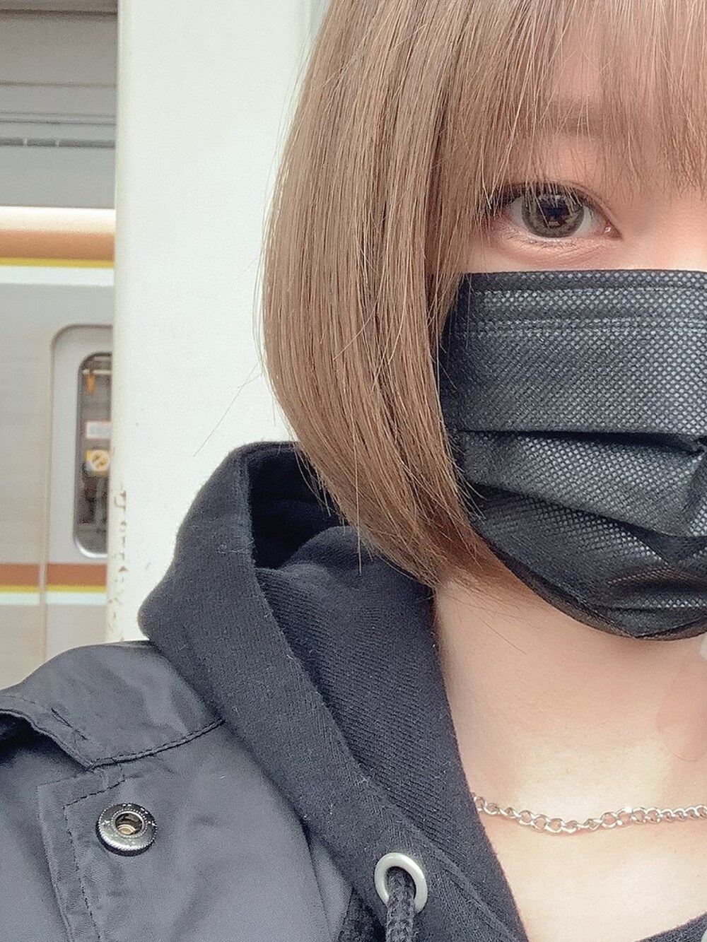 ブラック系のパーカー、ブルー系のデニムパンツ、ブラック系のナイロンジャケットを着用したレディースの冬コーディネートの5枚目の写真