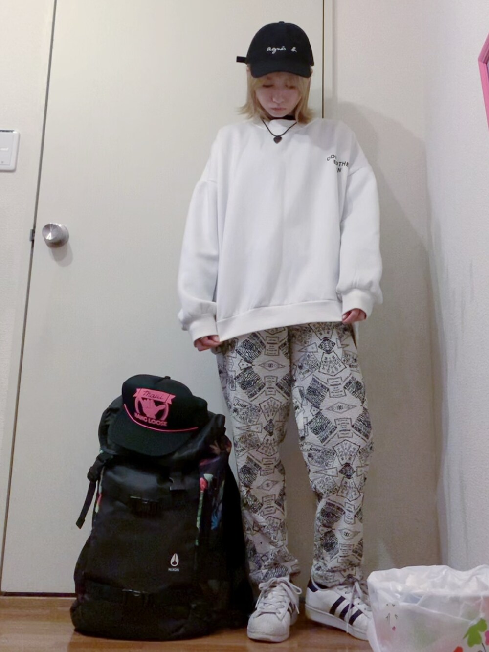 ブラック系のナイロンジャケット、ホワイト系のスウェット、ホワイト系のその他パンツを着用したレディースの春コーディネートの4枚目の写真