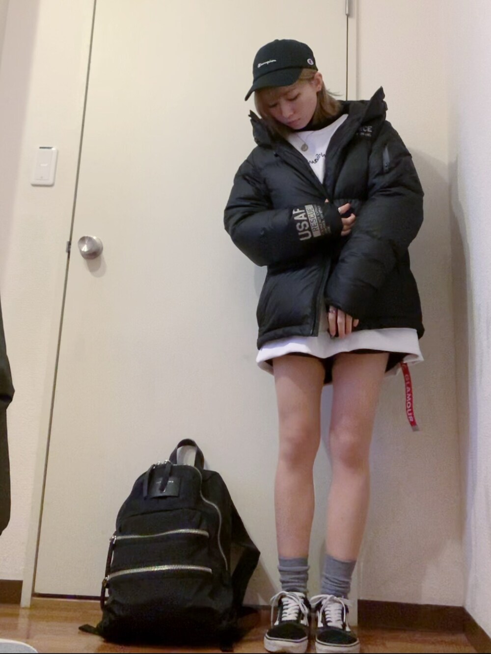 ホワイト系のスウェット、ブラック系のデニムパンツ、ブラック系のスニーカーを着用したレディースの冬コーディネートの5枚目の写真