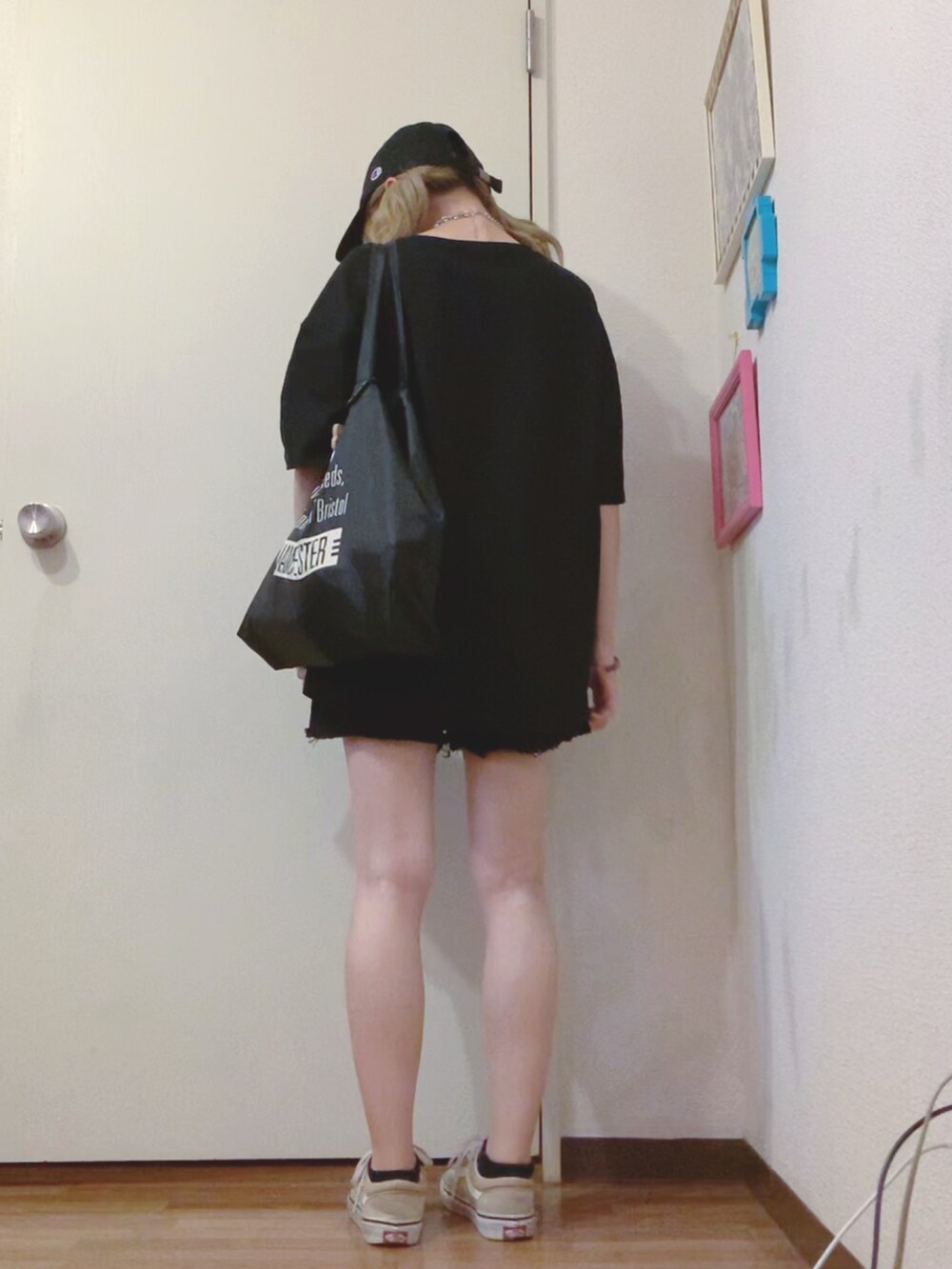 ブラック系のTシャツ/カットソー、ブラック系のデニムパンツ、ベージュ系のスニーカーを着用したレディースの夏コーディネートの2枚目の写真