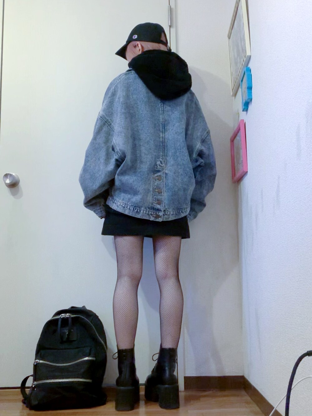 ブラック系のスウェット、ブラック系のスカート、ブルー系のデニムジャケットを着用したレディースの秋コーディネートの2枚目の写真