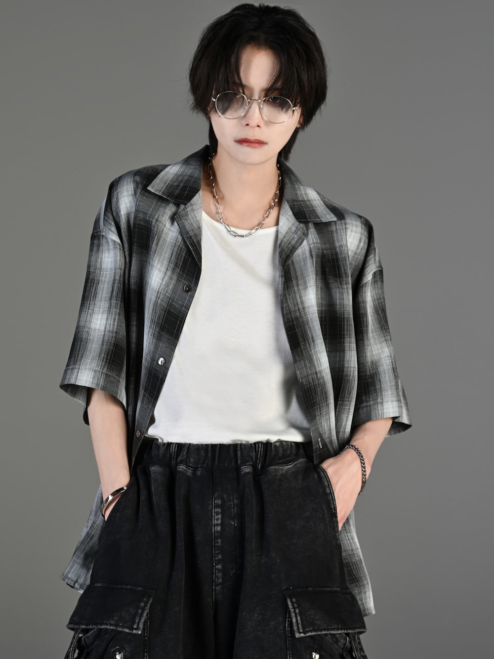 グレー系のタンクトップ、ブラック系のその他パンツ、ホワイト系のスニーカーを着用したメンズの春コーディネートの2枚目の写真