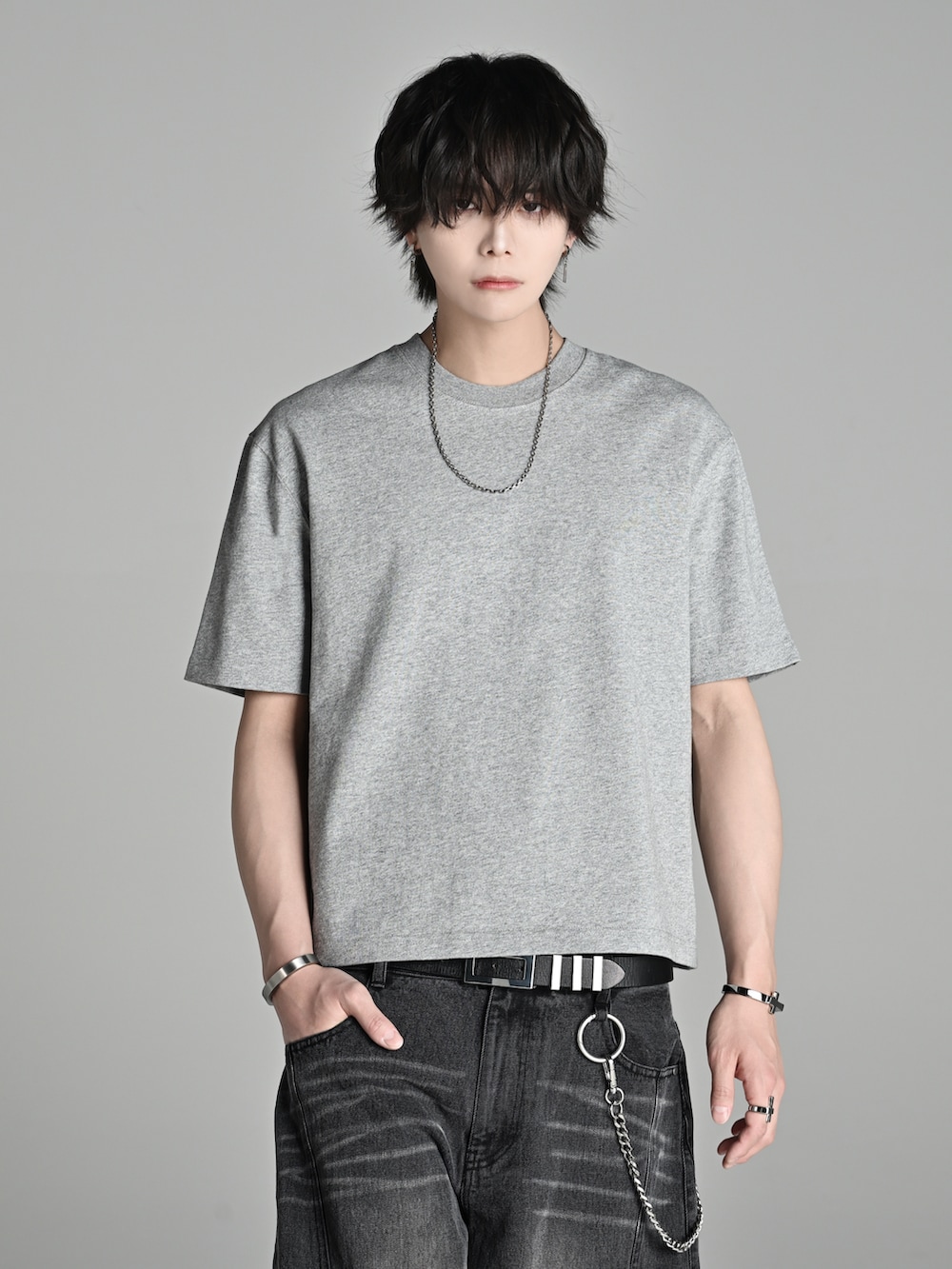 グレー系のTシャツ/カットソー、ブラック系のデニムパンツ、ブラウン系のブーツを着用したメンズの春コーディネートの4枚目の写真