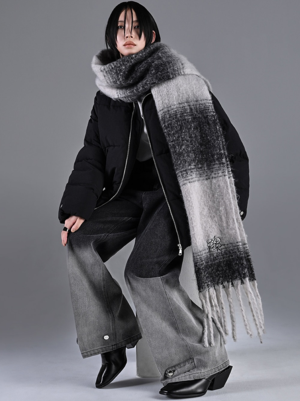 ブラック系のその他アウター、ブラック系のリング、シルバー系のピアス（両耳用）を着用したメンズの冬コーディネートの3枚目の写真