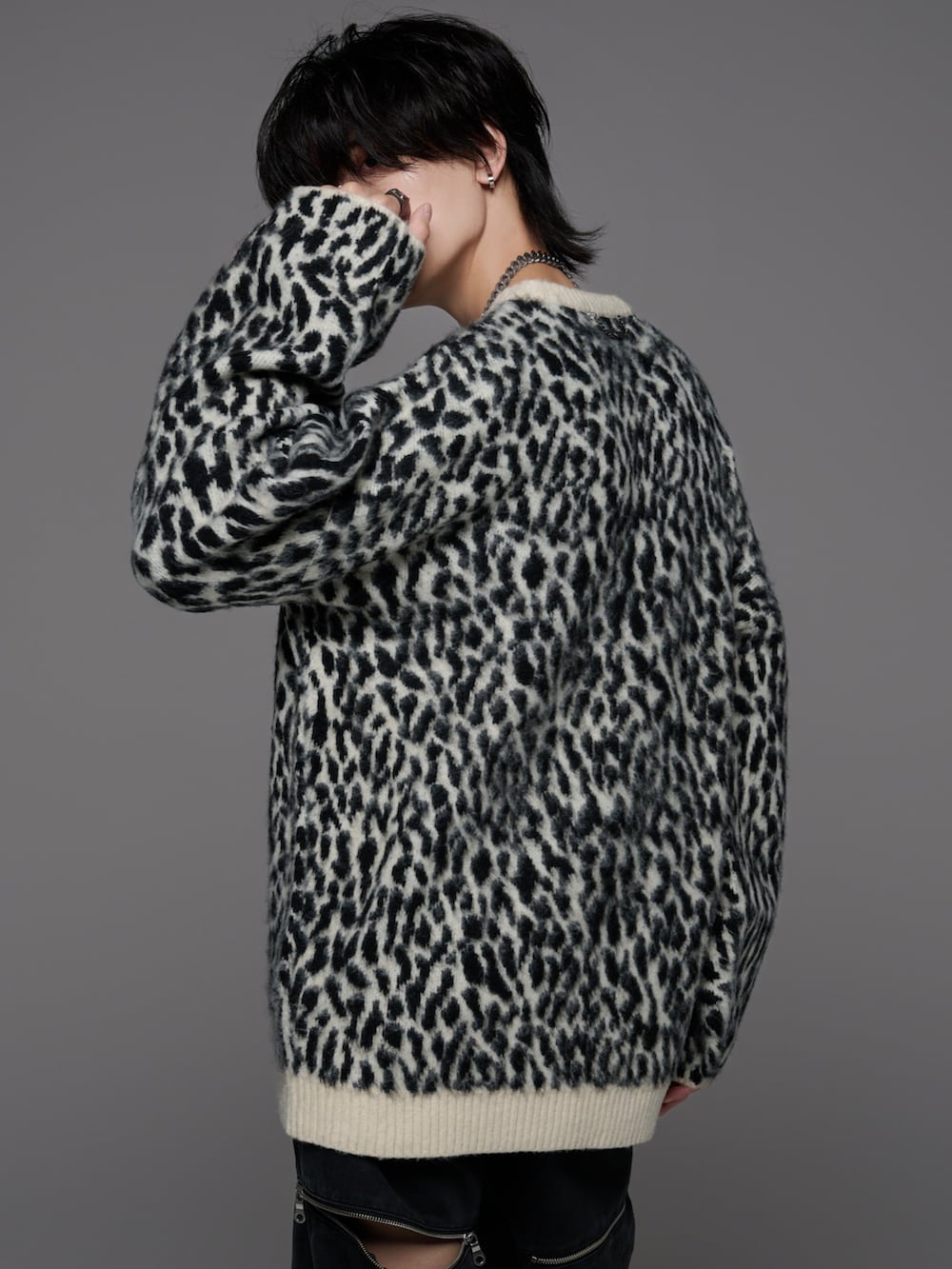 ブラック系のブーツ、その他のニット/セーター、グレー系のデニムパンツを着用したメンズの冬コーディネートの4枚目の写真