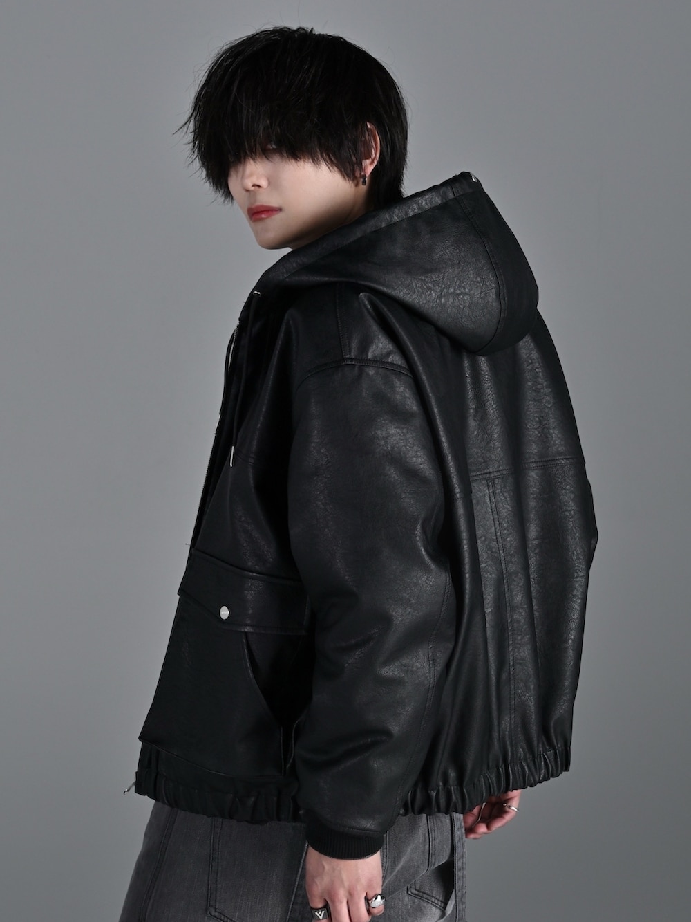 グレー系のスウェット、ブラック系のブルゾン、グレー系のデニムパンツを着用したメンズの春コーディネートの4枚目の写真