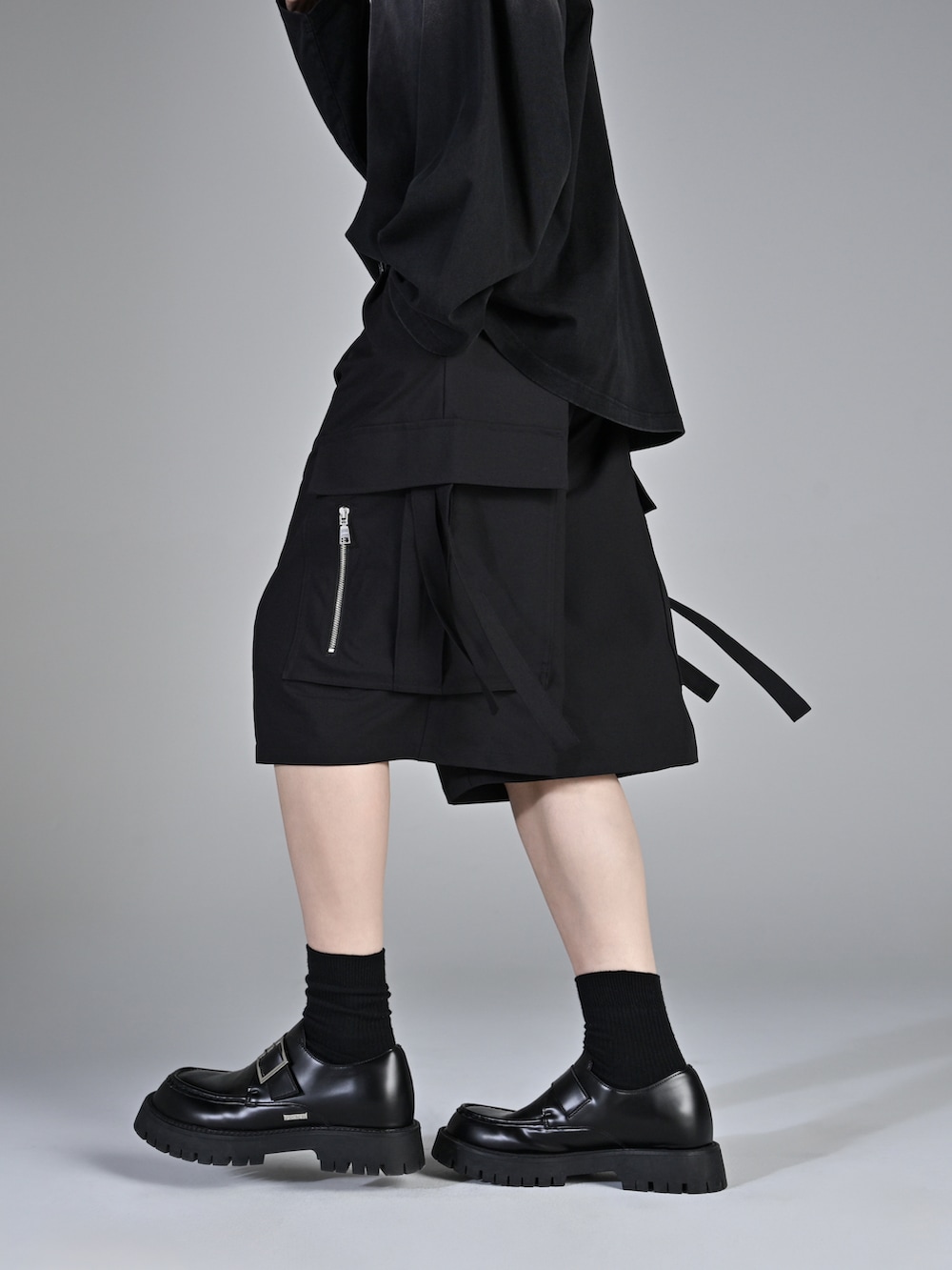 ブラック系のTシャツ/カットソー、ブラック系のスラックス、ブラック系のローファーを着用したメンズの春コーディネートの4枚目の写真