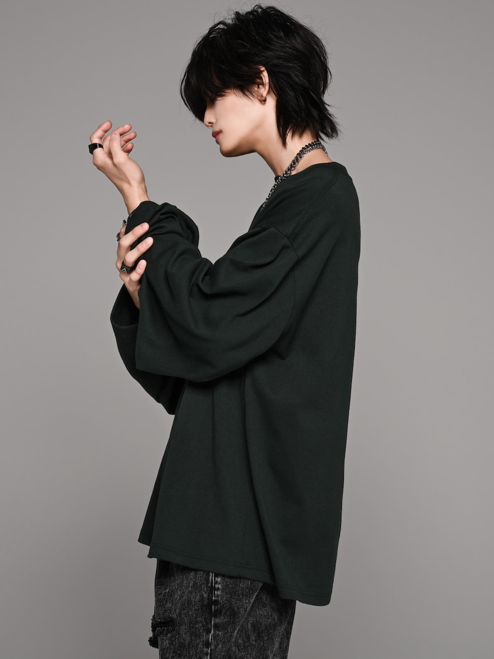 ブラック系のデニムパンツ、ホワイト系のスニーカー、グリーン系のTシャツ/カットソーを着用したメンズの夏コーディネートの3枚目の写真