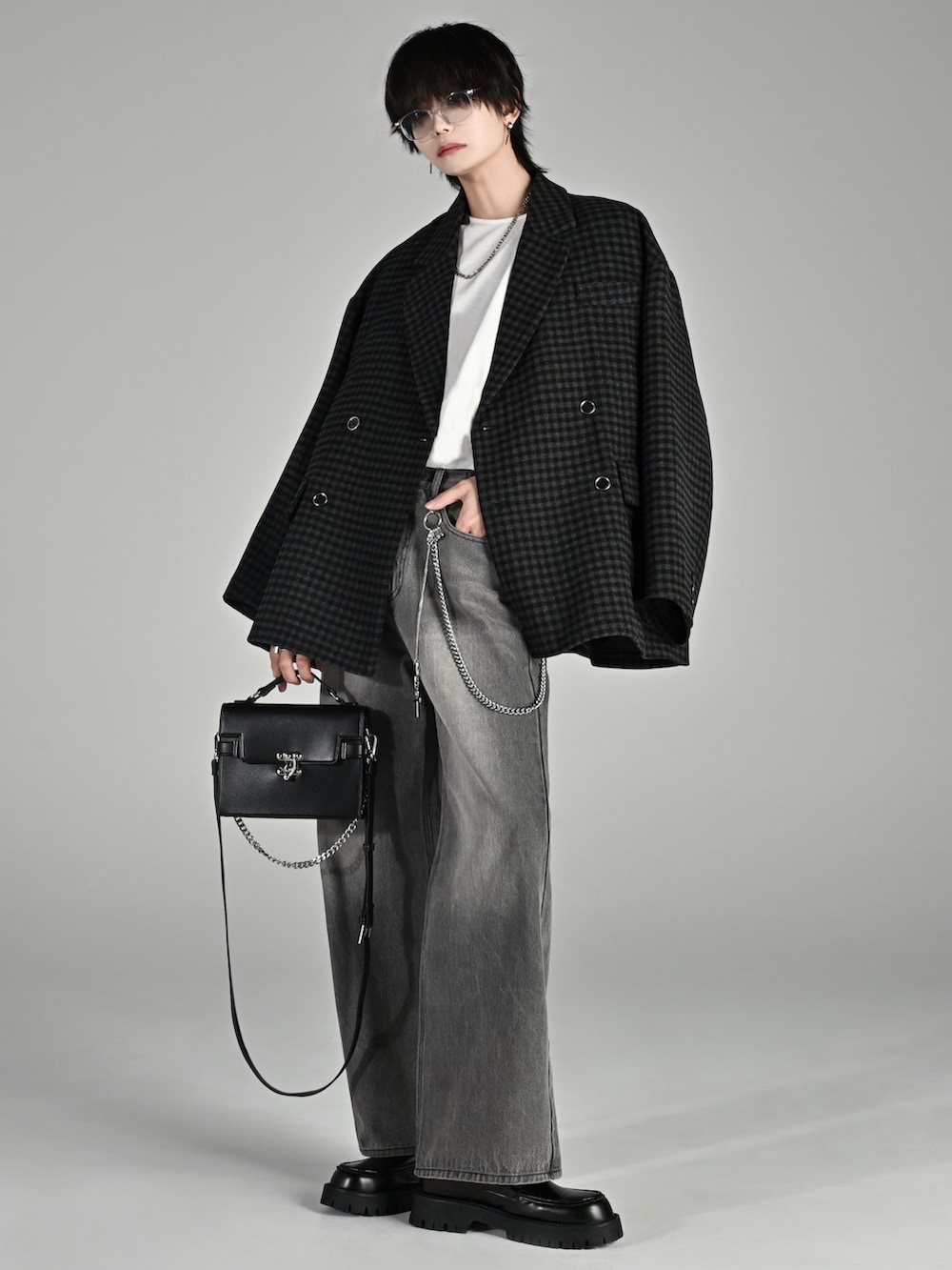 ブラック系のテーラードジャケット、ブラック系のスラックス、ブラック系のショルダーバッグを着用したメンズの秋コーディネートの3枚目の写真