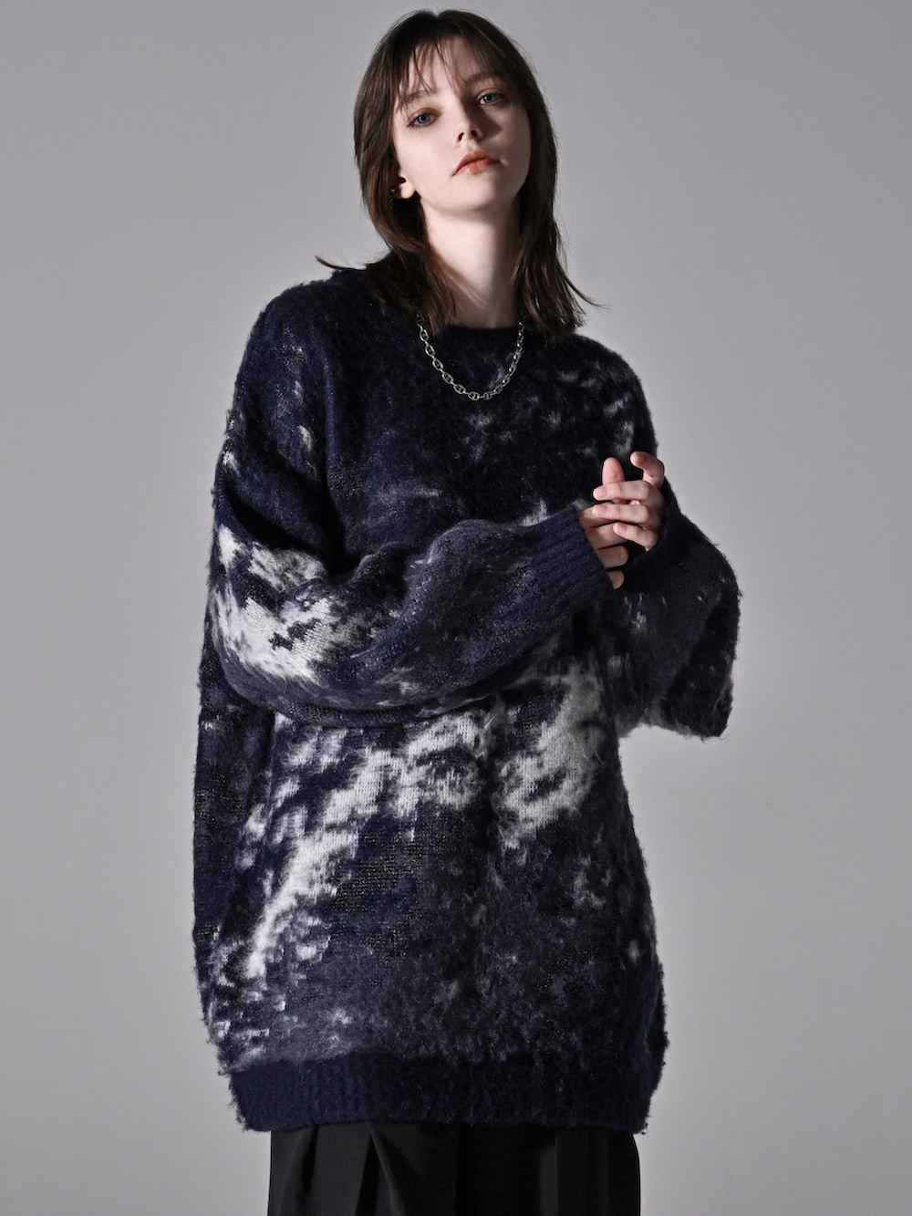 ブルー系のニット/セーター、グレー系のデニムパンツ、ブラック系のショルダーバッグを着用したメンズの秋コーディネートの3枚目の写真