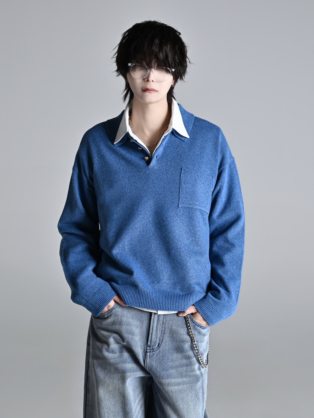 ブルー系のデニムパンツ、ブラック系のショルダーバッグ、ホワイト系のスニーカーを着用したメンズの冬コーディネートの2枚目の写真