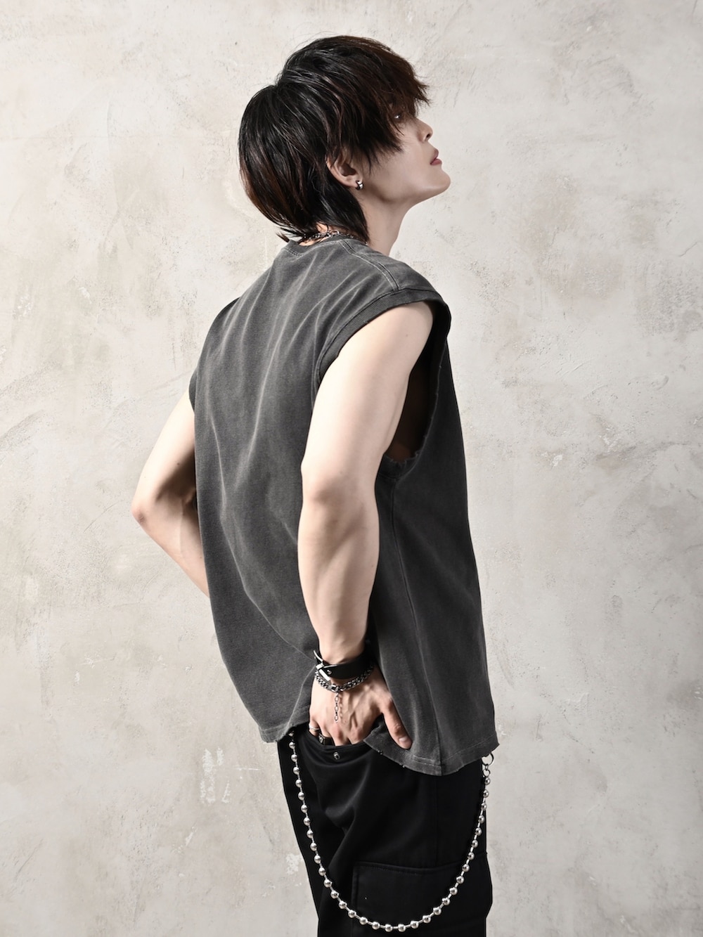 ブラック系のTシャツ/カットソー、ブラック系のカーゴパンツ、ホワイト系のスニーカーを着用したメンズの夏コーディネートの4枚目の写真