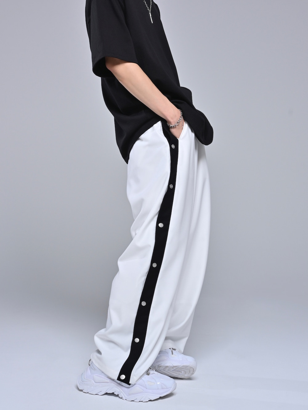 ブラック系のTシャツ/カットソー、ホワイト系のスニーカー、ホワイト系のその他パンツを着用したメンズの春コーディネートの4枚目の写真