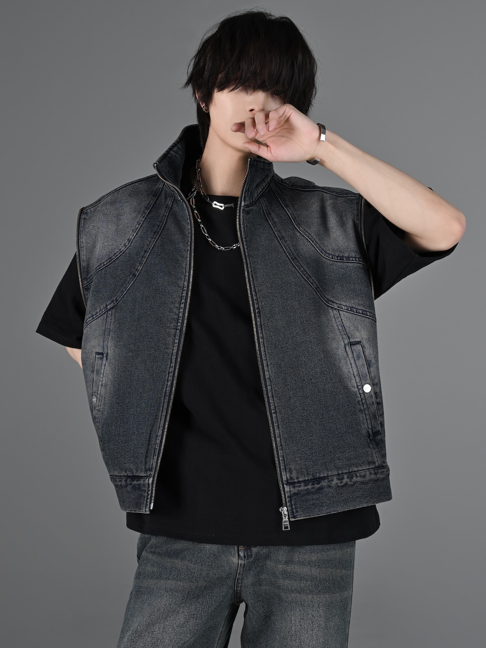 ブルー系のデニムパンツ、ホワイト系のスニーカー、グレー系のタンクトップを着用したメンズの冬コーディネートの5枚目の写真