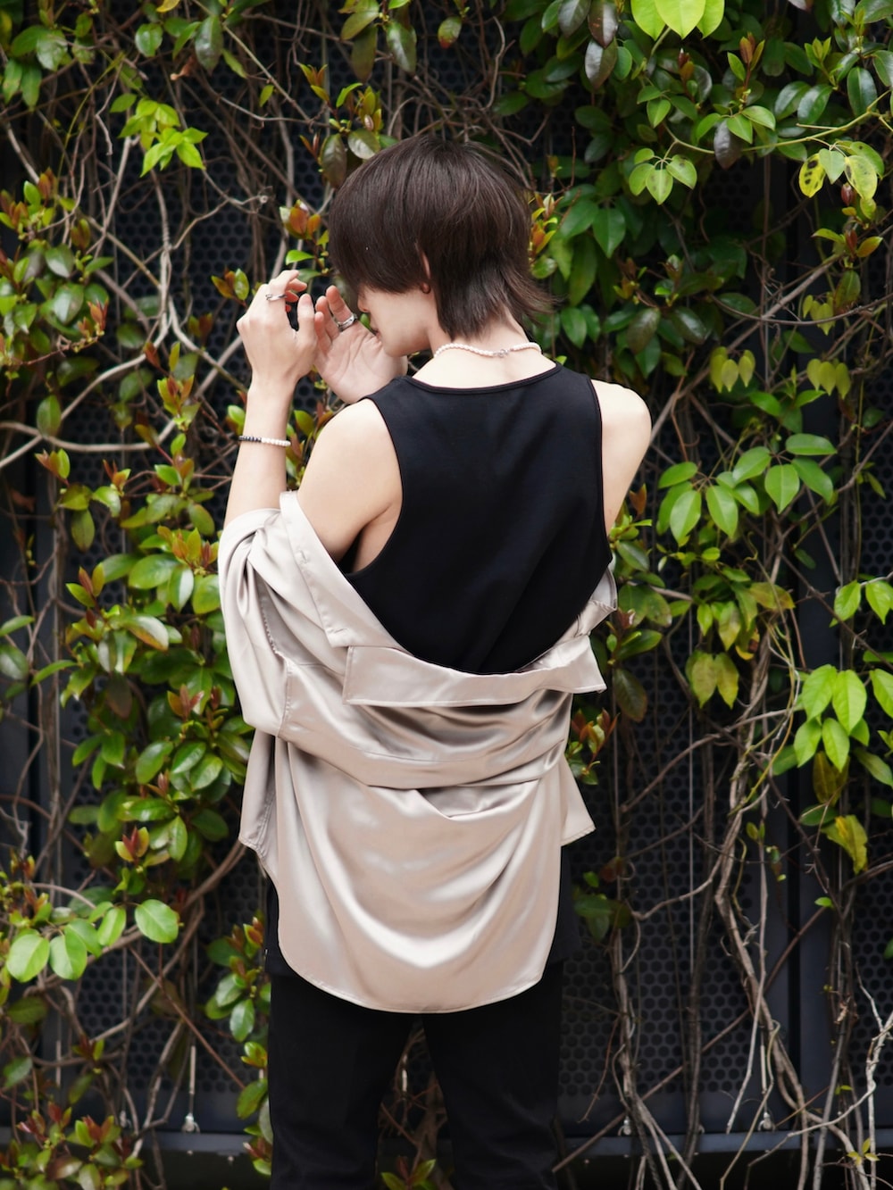 ブラック系のデニムパンツ、ベージュ系のトートバッグ、ブラック系のブーツを着用したメンズの春コーディネートの5枚目の写真