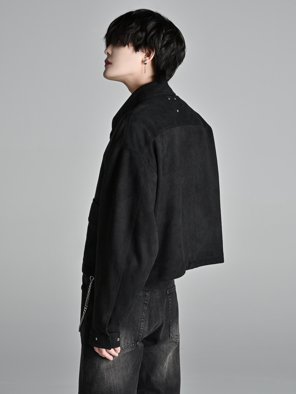 ブラック系のデニムパンツ、ブラック系のブーツ、ブラック系のショルダーバッグを着用したメンズの冬コーディネートの4枚目の写真