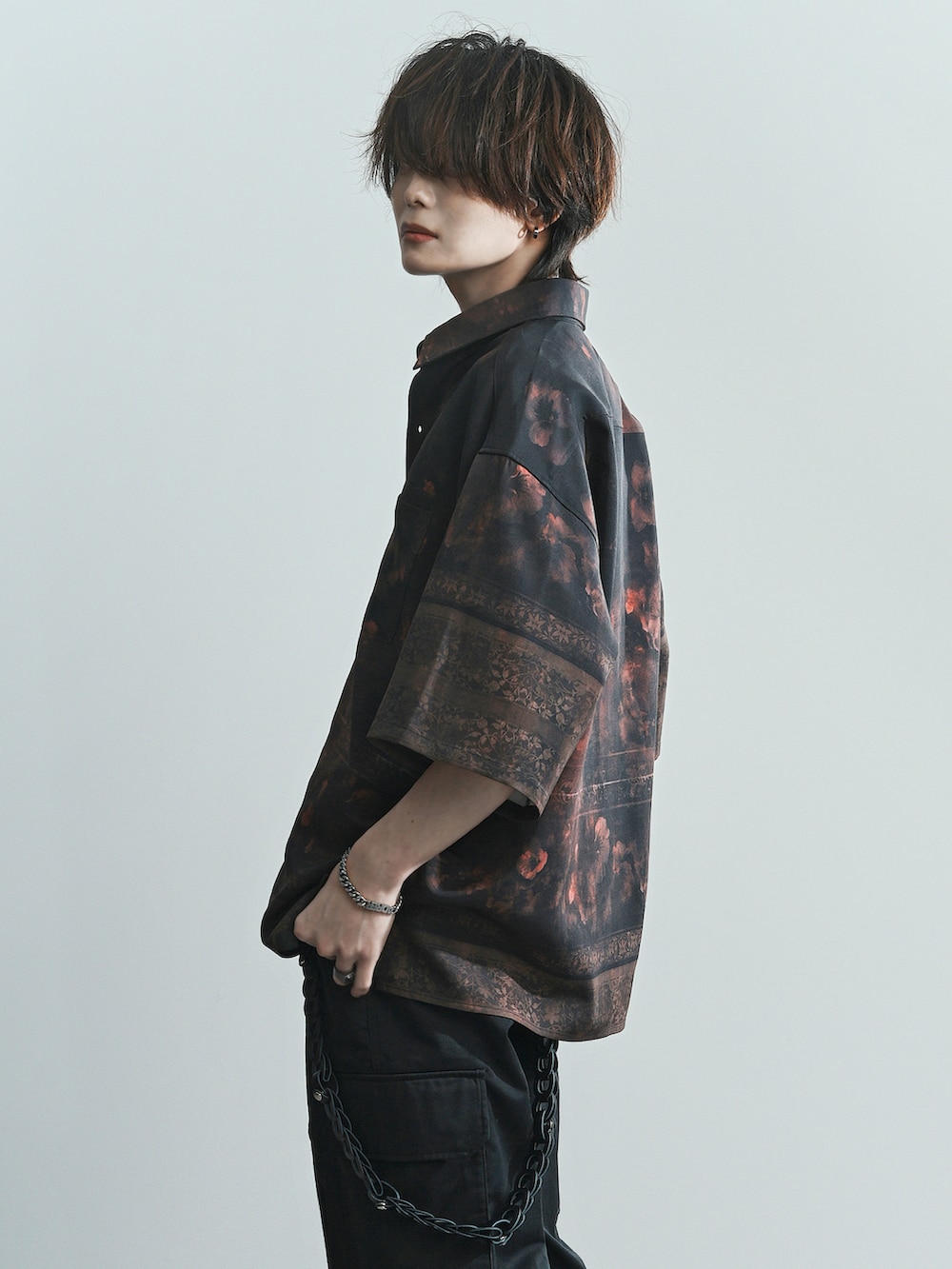 ブラック系のカーゴパンツ、ブラック系のブーツ、レッド系のシャツ/ブラウスを着用したメンズの夏コーディネートの3枚目の写真