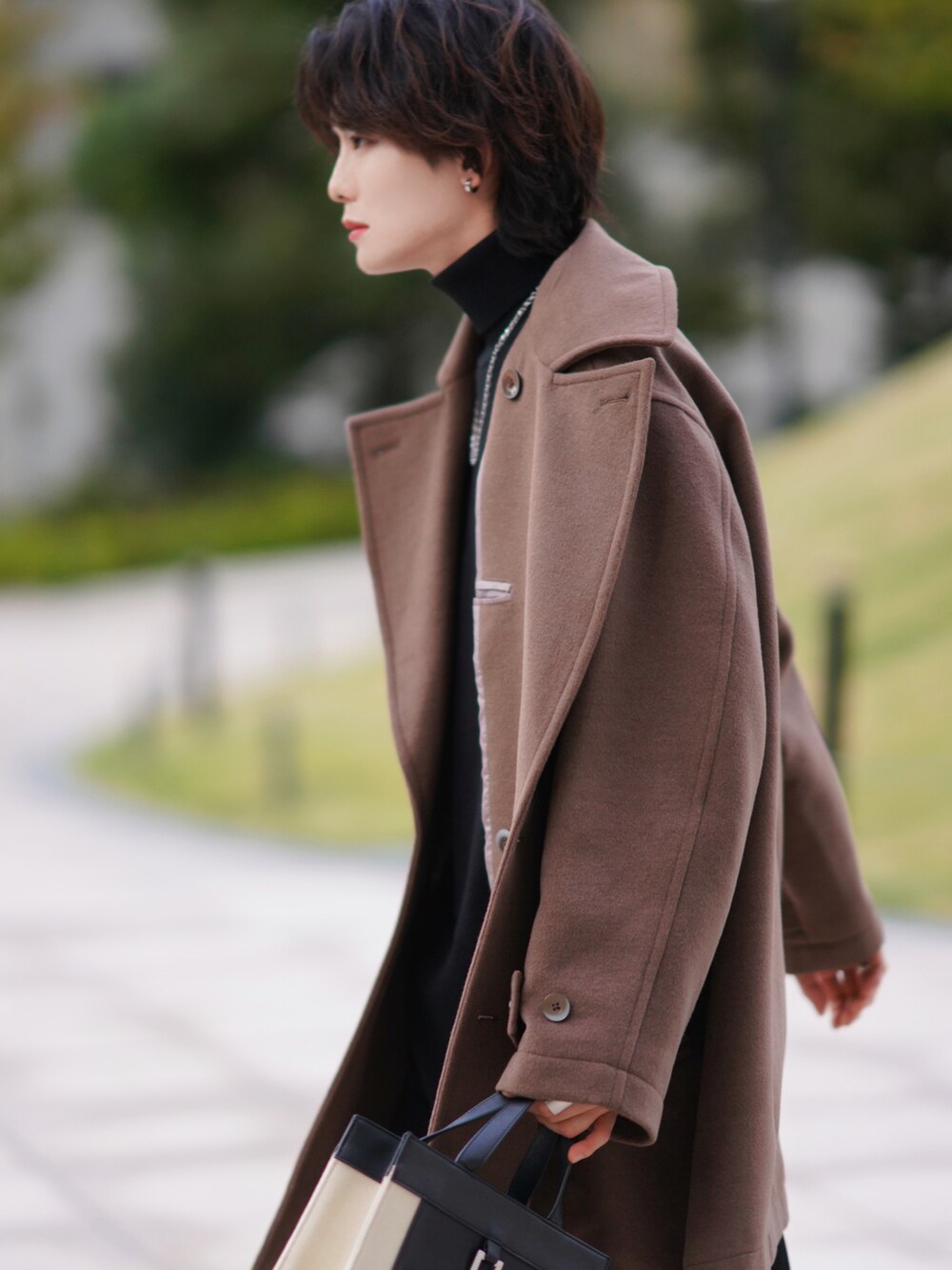 ブラック系のニット/セーター、ブラック系のデニムパンツ、ブラック系のブーツを着用したメンズの秋コーディネートの3枚目の写真