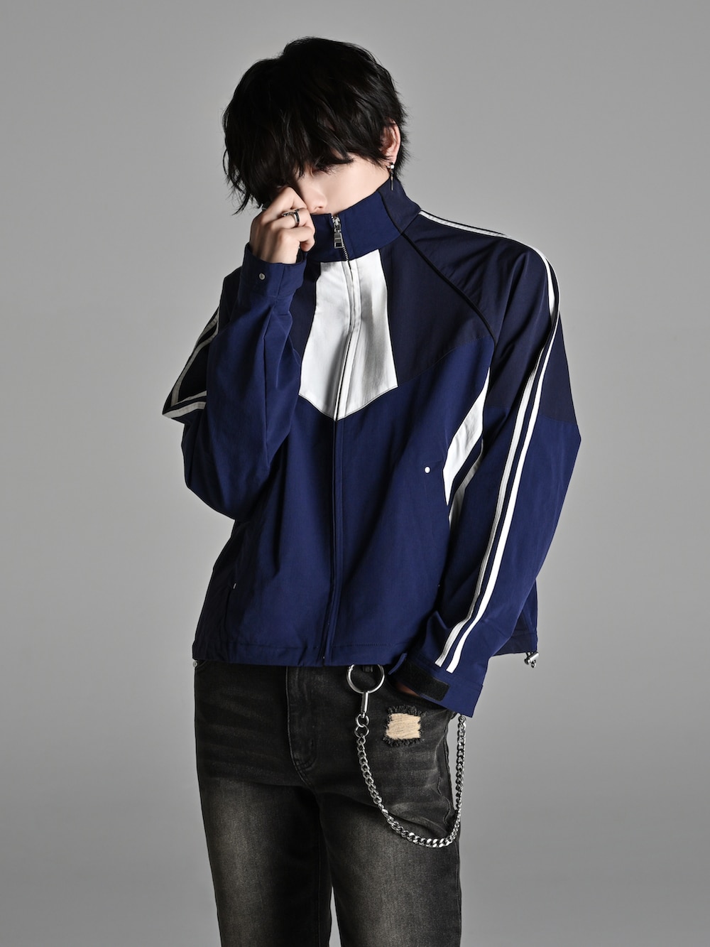 ブルー系のナイロンジャケット、ブラック系のデニムパンツ、ブラック系のショルダーバッグを着用したメンズの冬コーディネートの2枚目の写真