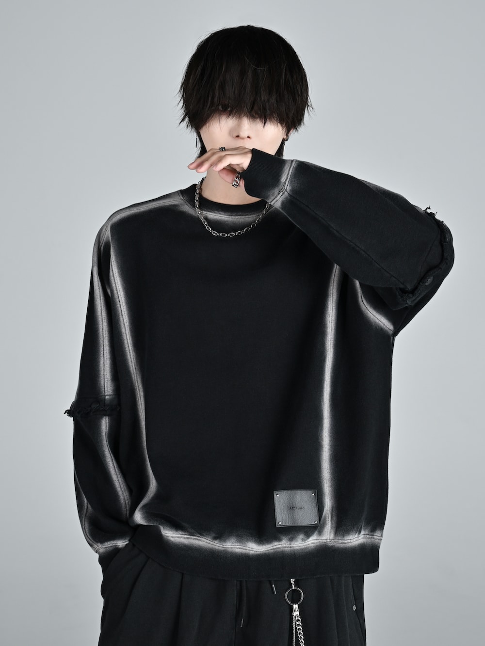 ホワイト系のスニーカー、ブラック系のスウェット、ブラック系のスウェットパンツを着用したメンズの秋コーディネートの2枚目の写真